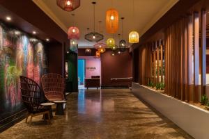 a hallway with chairs and chandeliers at Pan Pacific Perth in Perth