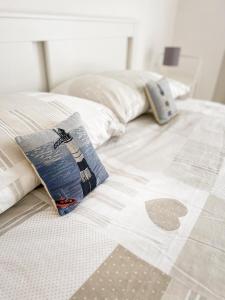 a bed with two pillows on top of it at La casa di Lory in Falconara Marittima