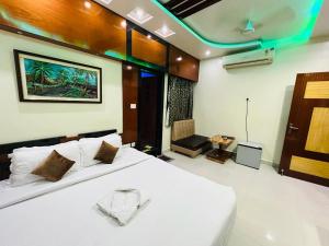 a bedroom with a large white bed in a room at Hotel Jk Residency in Muzaffarpur