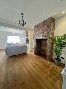 a bedroom with a bed and a brick fireplace at City Chester Entire House Central in Chester