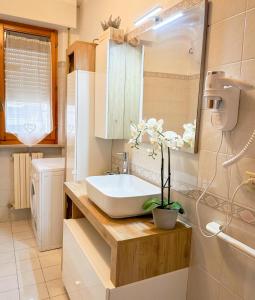 a bathroom with a sink and a mirror at La casa di Lory in Falconara Marittima