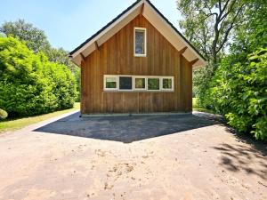 a house on a brick driveway with a building at Chalet with gorgeous view of the natural surroundings in Weerselo