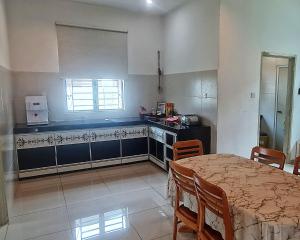 a kitchen with a table and chairs and a window at Siantan - Near Std Hang Jebat, Sg Udang & UITM Lendu in Melaka