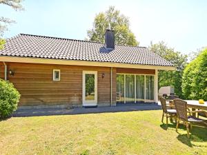 a house with a table and chairs in the yard at Chalet with gorgeous view of the natural surroundings in Weerselo