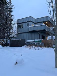 a building with a lot of snow in front of it at Ravens End in Dead Man's Flats