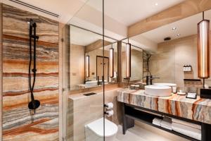 a bathroom with two sinks and a shower at Pan Pacific Perth in Perth