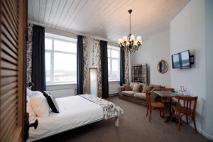 Silene Resort & SPA Egles Villa في Silene: غرفة نوم مع سرير وغرفة معيشة