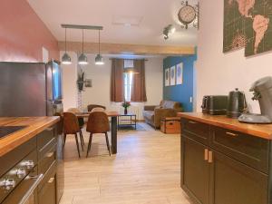 a kitchen with a table and a dining room at Lisloft Appartement à 5 Min du ZooParc de Beauval, Centre ville Saint-Aignan in Saint-Aignan