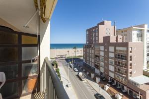 a view of the beach from a balcony of a building at Oratge in Playa de Gandia
