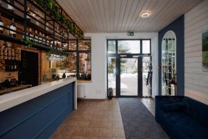 a restaurant with a bar with a blue counter at Silene Resort & SPA Egles Villa in Silene