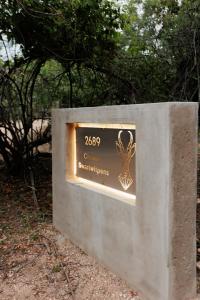 a sign with a trophy on top of a wall at Chawal @ Swartwithpens in Marloth Park