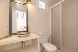 a bathroom with a toilet and a sink and a mirror at Binisagoc B in Binibeca +21 photos