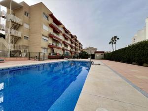 a swimming pool in front of a apartment building at Las Palomas Beach in Torremolinos