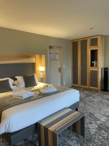 a hotel room with two beds in a room at Hotel Le Cercle in Cherbourg en Cotentin