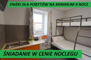 a dorm room with a bunk bed and a sink at Hostel Siennicka in Warsaw