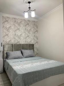 מיטה או מיטות בחדר ב-AZERBAYCAN