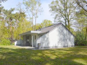 a small white house in the middle of a field at Alluring Holiday Home in Limburg near Forest in De Horst