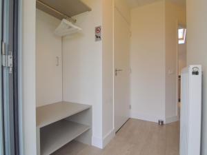a room with white walls and a walk in closet at Alluring Holiday Home in Limburg near Forest in De Horst