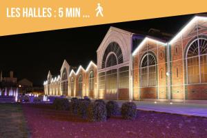 un grand bâtiment avec des lumières allumées la nuit dans l'établissement Le Cocoon, à Vierzon