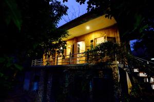 a house with a balcony in front of it at night at Duân Thảo homestay in Hòa Bình