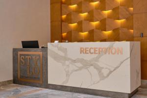 a reception desk with a sign that reads mystery lotto at STYLO Residences & Suites in Tashkent