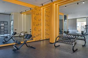 a gym with treadmills and elliptical machines at STYLO Residences & Suites in Tashkent