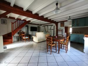 a kitchen and dining room with a table and chairs at Maison Bressanne in Sornay