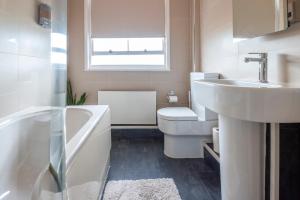a white bathroom with a sink and a toilet at Dazzling Room near Paddington/Elizabeth Stn in London