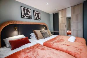 a bedroom with a large bed with red pillows at May Disc - Long Stay - Contractors in Bristol