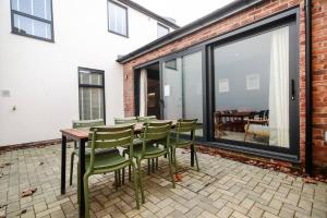 a patio with a table and chairs on a patio at May Disc - Long Stay - Contractors in Bristol