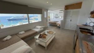 a hotel room with a bed and a view of the ocean at Mykonos Tourlos Nests - Sea View Escape in Tourlos