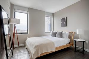 a bedroom with a bed and two windows at Blueground N Station gym wd nr T shops BOS-1004 in Boston