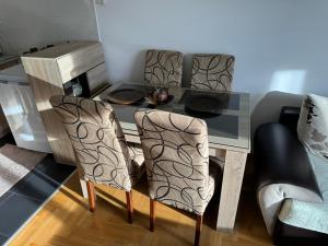 a dining room table with two chairs and a desk at Apartment 50 in Podgorica