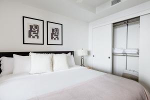 a white bedroom with a large bed with white pillows at SoMa 1br w concierge bbq ac nr I-80 SFO-1434 in San Francisco