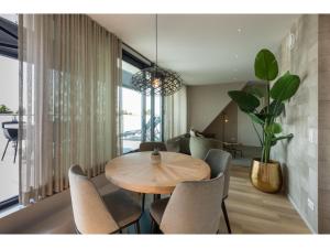 a dining room with a wooden table and chairs at Appealing apartment in Domburg near the beach in Domburg