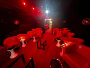 a red room with red chairs and candles at manorhaus RUTHIN - manorhaus collection in Ruthin