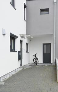 a bike parked in the courtyard of a white building at Business Living Oberkochen in Oberkochen