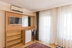 Televízia a/alebo spoločenská miestnosť v ubytovaní Deniz Houses