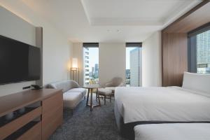 a hotel room with a bed and a flat screen tv at Premier hotel -CABIN PRESIDENT- Tokyo in Tokyo