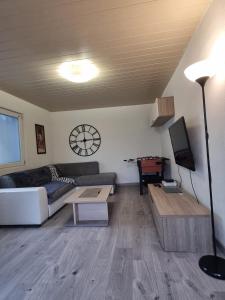 uma sala de estar com um sofá e uma mesa em MAISON COSY 7 minutes des frontières em Rosenau