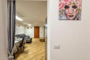 een woonkamer met een tafel en een schilderij aan de muur bij Villa Lina in Castelsardo