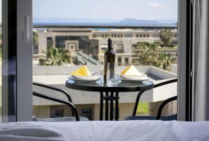 a table with a bottle of wine on top of a balcony at Kolymvari Hills in Chania