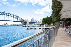 a view of a bridge over a river with a city at Harbourside Apartment with Spectacular Pool in Sydney