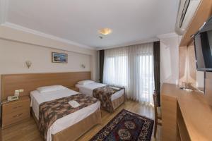Postel nebo postele na pokoji v ubytování Deniz Houses