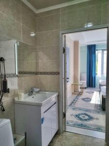 a bathroom with a shower and a sink and a tub at Royal Ak-Terek Issyk-kul in Ak-Terek +43 photos