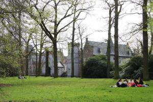 a group of people sitting on the grass in a park at Boxtel, Appartement (1-4p) nabij station/centrum in Boxtel