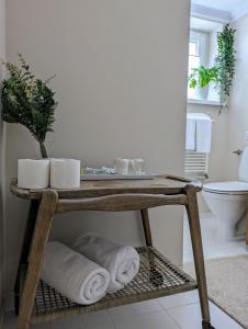 a bathroom with a table with towels and a toilet at Muelle in Kołobrzeg