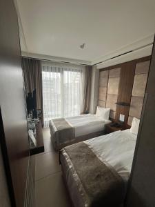 a hotel room with two beds and a window at Four Sides Beyoglu in Istanbul