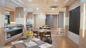 a restaurant with tables and chairs in a room at Abadi Hotel Malioboro Yogyakarta by Tritama Hospitality in Yogyakarta