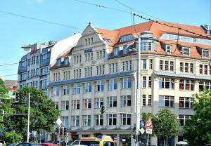 a large building on a city street with a taxi at Royal International Leipzig in Leipzig